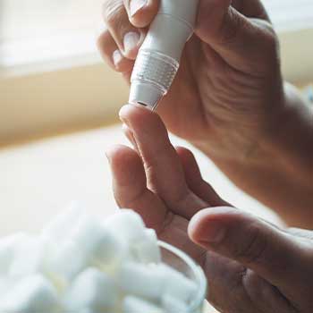 Diabetes blood check and sugar cubes